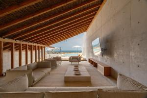 a living room with couches and a table at Casa Talá by Lumina in Puerto Escondido