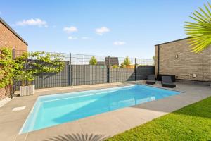 a swimming pool in the backyard of a house at Modo Apartment in Erkelenz mit Sauna Pool in Erkelenz