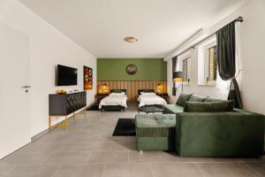 a living room with a couch and a tv at Modo Apartment in Erkelenz mit Sauna Pool in Erkelenz