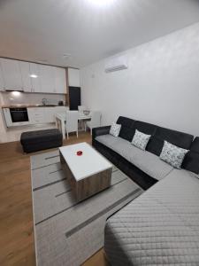 a living room with a couch and a coffee table at Apartman Sunce in Posušje