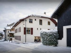 a white house with snow on the roof at Villa Le Cep - OVO Network in Menthon-Saint-Bernard