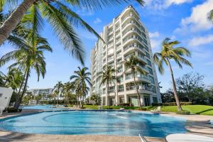 a hotel with a swimming pool in front of a building at Luxury Beach Condo with Resort Access Vidanta in Nuevo Vallarta