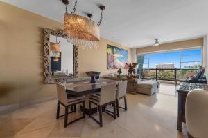 a dining room with a table and chairs at Luxury Beach Condo with Resort Access Vidanta in Nuevo Vallarta