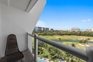 a balcony with a view of a golf course at Luxury Beach Condo with Resort Access Vidanta in Nuevo Vallarta