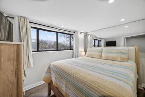 a bedroom with a bed and two windows at Indoor/Outdoor Pools!! Hot Tub! Steam Room! Sauna! in Osage Beach +61 photos