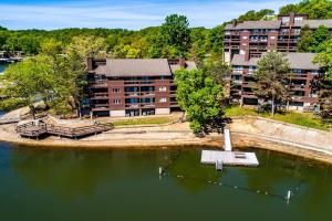 an aerial view of a building next to a body of water at Indoor/Outdoor Pools!! Hot Tub! Steam Room! Sauna! in Osage Beach