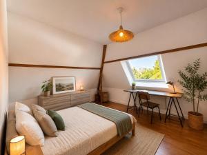 a bedroom with a bed and a desk and a window at Ecolocs Caen Beuville in Caen