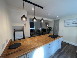 a kitchen with a wooden counter top in a room at Serene escape in Cleator Moor