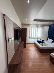a room with a bed and a tv in it at Hotel Royal Suites in Ajmer