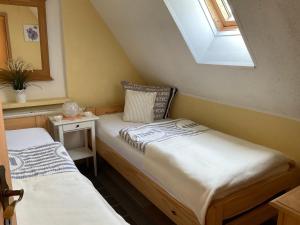 two twin beds in a room with a window at Rügen Fewo 307 in Sagard