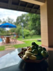 a bowl of fruit sitting on top of a table at Hotel Boutique Casa Bonanza in Guamal