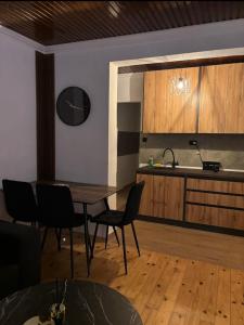 a kitchen with a table and chairs and a sink at Vikendica Dajana in Banja Luka