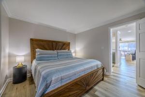 a bedroom with a large bed with a wooden headboard at 22 Mile Marker! Indoor/Outdoor Pools, Hot Tub! New in Osage Beach +79 photos