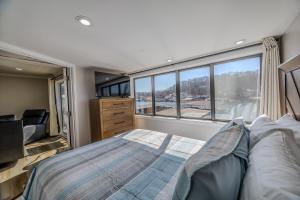 a bedroom with a bed and a large window at 22 Mile Marker! Indoor/Outdoor Pools, Hot Tub! New in Osage Beach