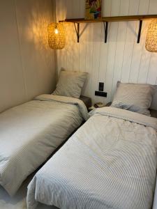 two beds sitting next to each other in a room at Retour de Plage in Saint-Pair-sur-Mer +15 photos