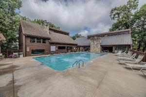 a swimming pool in front of a house at 22 Mile Marker! Indoor/Outdoor Pools, Hot Tub! New in Osage Beach