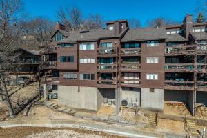 an apartment building with balconies on the side of it at 22 Mile Marker! Indoor/Outdoor Pools, Hot Tub! New in Osage Beach