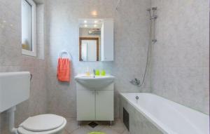 a bathroom with a white toilet and a sink at Holiday house Casa Vida in Rakalj +13 photos