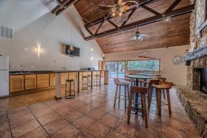 a large kitchen with a table and some bar stools at 22 Mile Marker! Indoor/Outdoor Pools, Hot Tub! New in Osage Beach