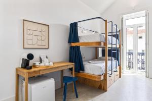 a bedroom with a bunk bed and a desk at Salt&Flow in Parede