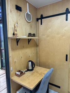 a small kitchen with a wooden table with a tea kettle on it at Пан0рама in Saty