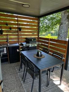 a patio with a table and chairs and a stove at NOBLEJA - BIG BERRY - Kolpa - Metlika in Gradac +34 photos