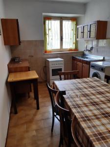 a kitchen with a table and some chairs and a table and a tableablish at la casa nell'acropoli , piano terra in Arpino
