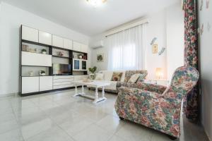 a living room with a couch and a table at Sea Zen in Paleo Tsifliki +14 photos