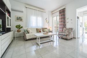 a living room with a couch and a table at Sea Zen in Paleo Tsifliki