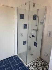 a shower with a glass door in a bathroom at Le Paradis in Belfort +6 photos