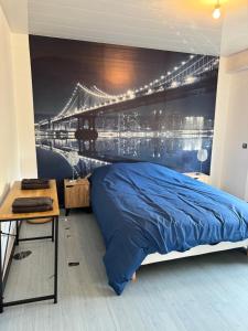 a bedroom with a bed and a bridge mural at Le Paradis in Belfort