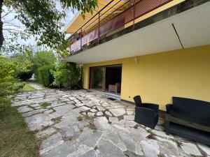 a patio with two chairs and a building at Le Paradis in Belfort