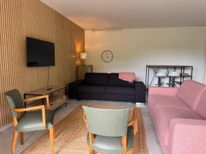 a living room with a couch and a table at Le Paradis in Belfort