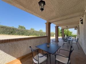 a patio with tables and chairs on a wall at Relais Casale Corvo in Guglionesi