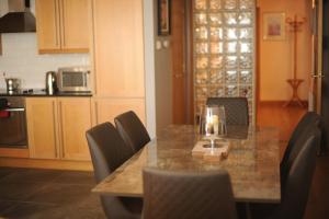 a kitchen with a table and chairs with a candle on it at Portstewart promenade apartment with sea views in Portstewart