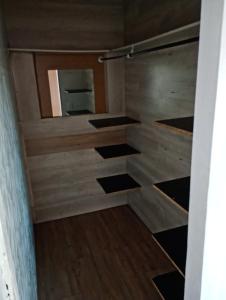 a bathroom with a wooden wall and a mirror at Pousada Marlin in Dois Vizinhos