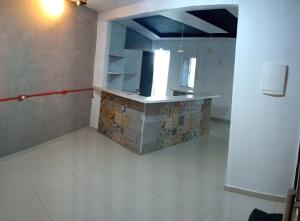 a kitchen with a counter in a room at Pousada Marlin in Dois Vizinhos