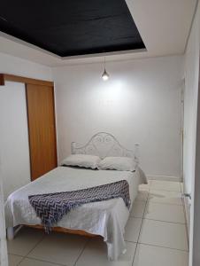 a bedroom with a bed with a black ceiling at Pousada Marlin in Dois Vizinhos