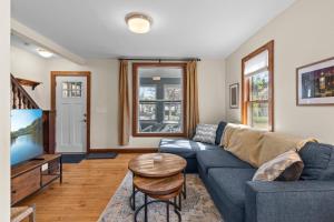a living room with a couch and a table at The Longfellow Bungalow in Minneapolis