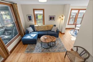 a living room with a blue couch and a table at The Longfellow Bungalow in Minneapolis