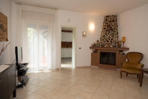 a living room with a fireplace and a television at Natura e Relax Casa Emma in Buonvicino