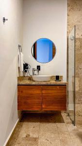 a bathroom with a sink and a mirror at Amaka Calma Tulum by Cercana in Tulum