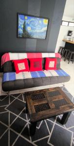 a living room with a couch and a coffee table at Loft zona centro La Merced in San Cristóbal de Las Casas +2 photos