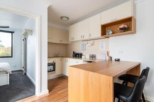 a kitchen with a wooden counter top in a room at Richmond apartment close to MCG in Melbourne