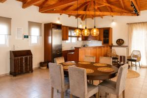 a kitchen and dining room with a table and chairs at Niobe Luxury Residence in Loutraki +18 photos