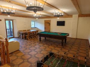 a room with a pool table and a dining room at Brižių sodyba in Brižiai