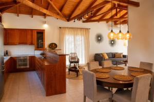 a kitchen and living room with a table and a dining room at Niobe Luxury Residence in Loutraki