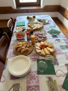 a table with a table cloth with food on it at Stanza Cuori Malga Ciauta in Villanova