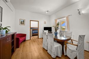 a dining room with a table and chairs at Pool Apartments Franko - Shared Pool in Ližnjan
