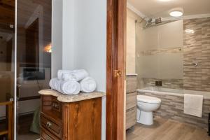 a bathroom with a toilet and a sink and a shower at Casa da Muralha in Beja +26 photos